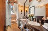 This luxurious bathroom boasts a rustic yet elegant design, perfect for a cozy retreat.