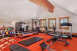 Step into your dream home gym! This space boasts a variety of workout equipment, including weight machines, free weights, and cardio machines, perfect for any fitness enthusiast.