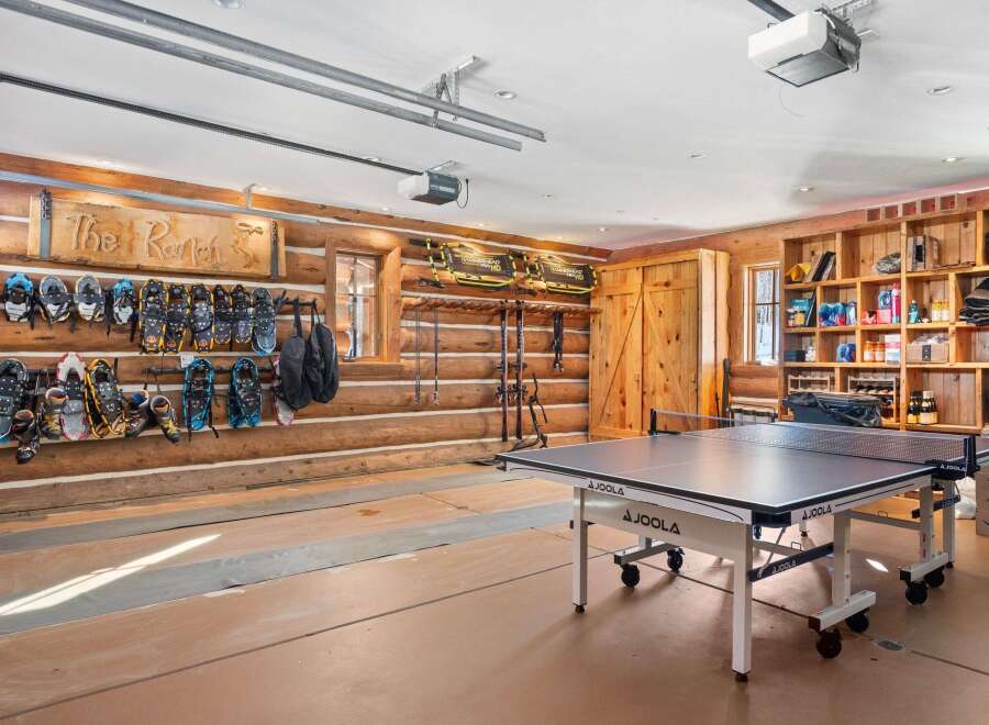 This stunning property boasts a unique garage space, perfect for both recreation and storage.