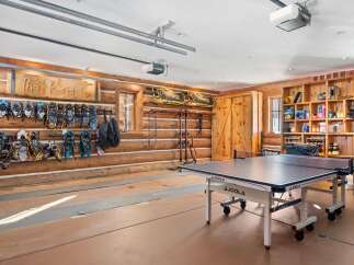 This stunning property boasts a unique garage space, perfect for both recreation and storage.