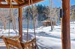 Experience the tranquility of winter in this stunning log cabin retreat.