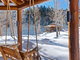 Experience the tranquility of winter in this stunning log cabin retreat.
