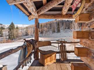Experience the charm of this rustic cabin, nestled in a winter wonderland.