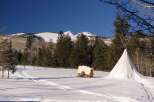 Experience the tranquility of this winter wonderland property, featuring a charming covered wagon and a traditional teepee.