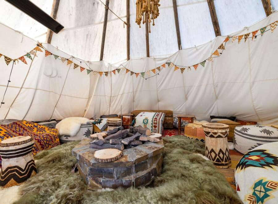 Step into a cozy and inviting teepee retreat, perfect for relaxation and gatherings.