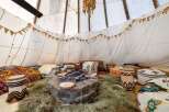 Step into a cozy and inviting teepee retreat, perfect for relaxation and gatherings.