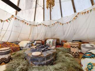 Step into a cozy and inviting teepee retreat, perfect for relaxation and gatherings.