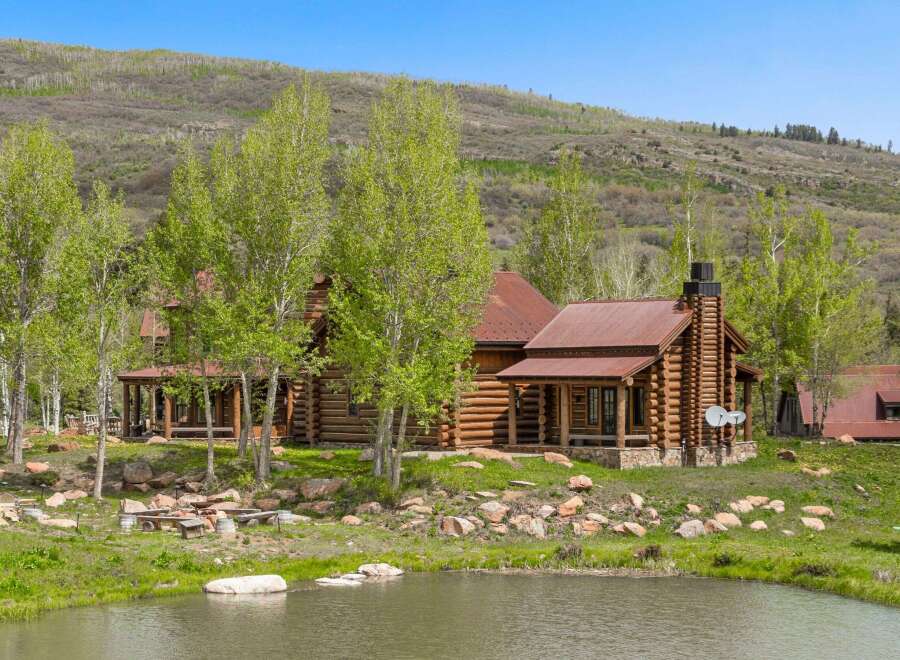 This stunning log cabin offers a serene retreat with its rustic charm and picturesque setting.