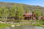 This stunning log cabin offers a serene retreat with its rustic charm and picturesque setting.
