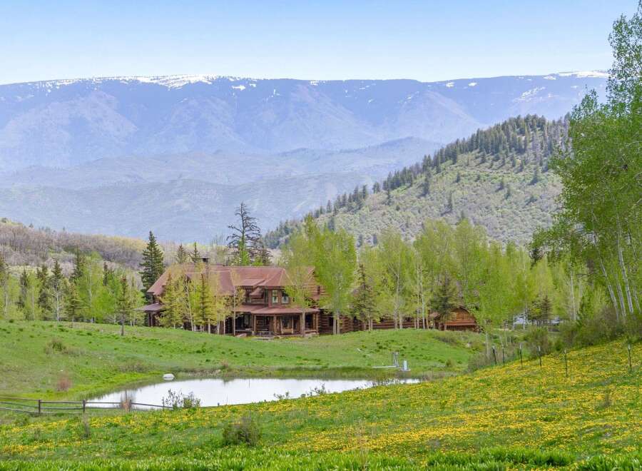 Nestled amidst the breathtaking mountain landscape, this stunning property boasts a luxurious log cabin home.