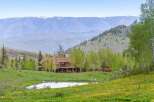 Nestled amidst the breathtaking mountain landscape, this stunning property boasts a luxurious log cabin home.