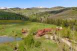 Escape to your dream retreat! This stunning property boasts a luxurious lodge-style home, a charming cabin, and a serene pond, all nestled in a breathtaking mountain landscape.