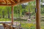 Experience rustic charm with this picturesque log cabin nestled amidst lush greenery and a serene lake.