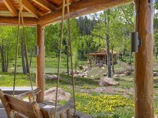 Experience rustic charm with this picturesque log cabin nestled amidst lush greenery and a serene lake.