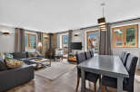 Discover the charm of this stunning property, featuring a cozy living area with a fireplace and a modern dining space.