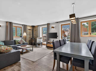 Discover the charm of this stunning property, featuring a cozy living area with a fireplace and a modern dining space.