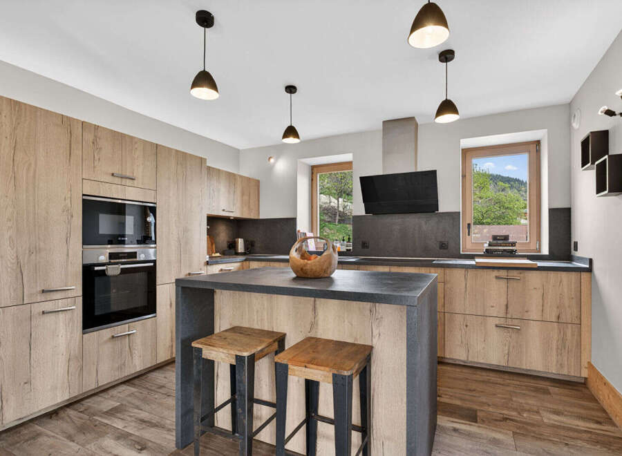 This stunning kitchen boasts modern design with a touch of rustic charm.