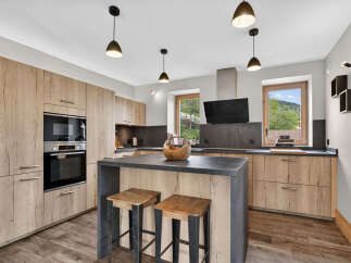 This stunning kitchen boasts modern design with a touch of rustic charm.