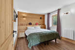 Experience the charm of this cozy bedroom, featuring a rustic wooden headboard that adds warmth and character.