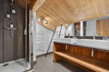 This stunning bathroom boasts a rustic charm with its wooden accents and modern amenities.