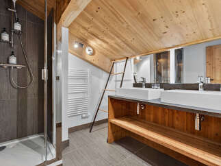 This stunning bathroom boasts a rustic charm with its wooden accents and modern amenities.