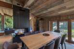 Experience luxury living in this stunning chalet featuring a modern fireplace and a spacious dining area.