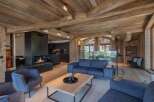 Experience luxury living in this stunning chalet, featuring a cozy fireplace and a modern kitchen.