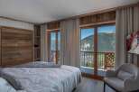 Experience the ultimate in luxury living with this stunning bedroom featuring breathtaking mountain views.