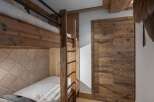 This cozy bedroom features custom-built bunk beds, perfect for accommodating guests or family members.