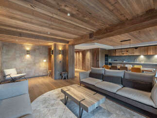 Experience rustic elegance in this stunning property, featuring a warm, inviting interior with exposed wooden beams and paneling.