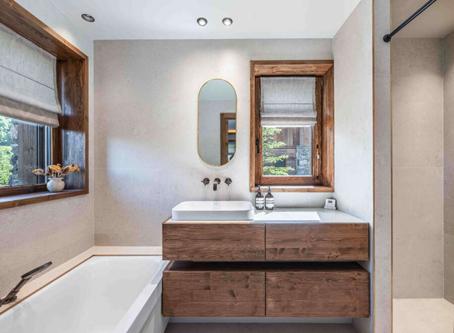 This luxurious bathroom boasts a modern design with natural wood accents.
