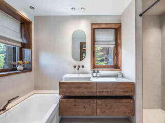 This luxurious bathroom boasts a modern design with natural wood accents.