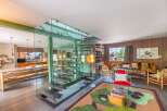 Step into modern luxury with this stunning property, showcasing a unique glass staircase and an open-concept design.
