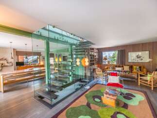 Step into modern luxury with this stunning property, showcasing a unique glass staircase and an open-concept design.
