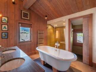 This luxurious bathroom features a stunning clawfoot tub, perfect for a relaxing soak.