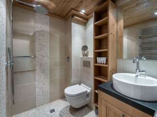 This luxurious bathroom features a modern design with a touch of rustic charm.