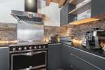 Discover the epitome of culinary luxury in this stunning kitchen! Featuring a high-end range, stainless steel hood, and sleek countertops, this space is designed for both style and functionality.