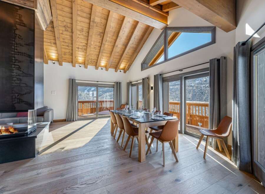 Experience luxury living in this stunning property featuring a spacious dining area with a modern fireplace.