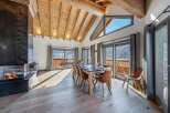 Experience luxury living in this stunning property featuring a spacious dining area with a modern fireplace.