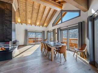 Experience luxury living in this stunning property featuring a spacious dining area with a modern fireplace.