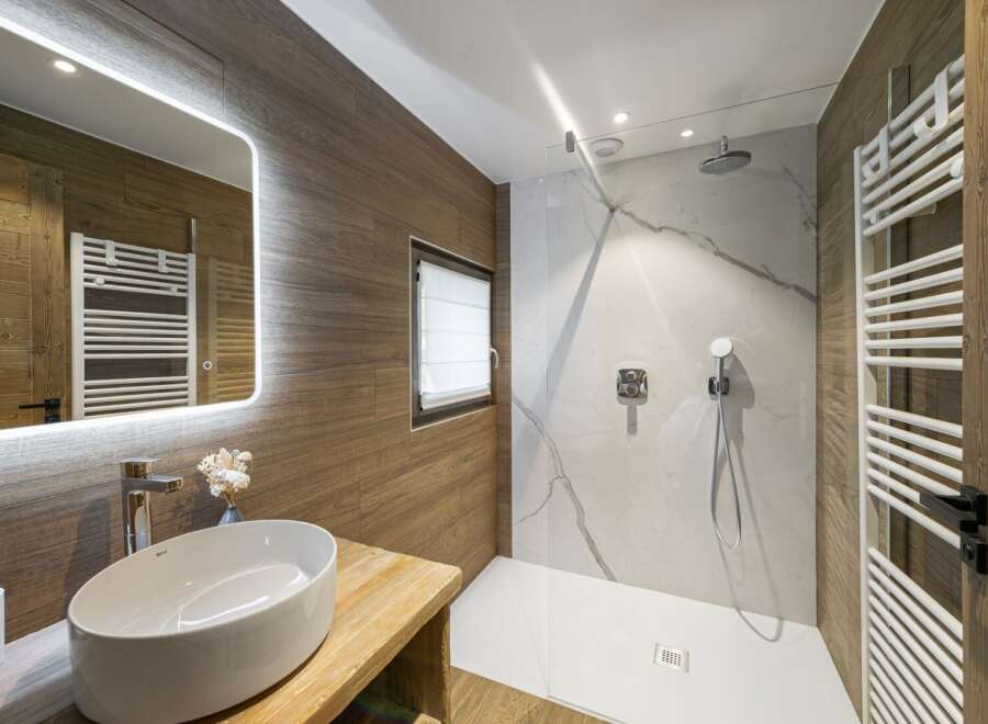 Step into a luxurious bathroom retreat, showcasing a modern design with natural wood accents.