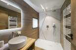 Step into a luxurious bathroom retreat, showcasing a modern design with natural wood accents.