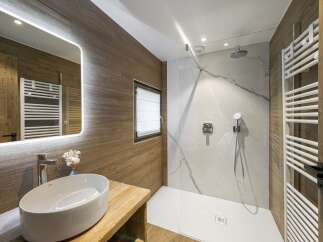 Step into a luxurious bathroom retreat, showcasing a modern design with natural wood accents.