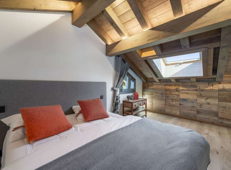 Experience the charm of this stunning bedroom, featuring a unique wooden ceiling and walls that exude warmth and character.