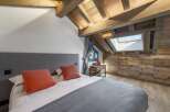 Experience the charm of this stunning bedroom, featuring a unique wooden ceiling and walls that exude warmth and character.