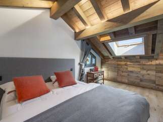 Experience the charm of this stunning bedroom, featuring a unique wooden ceiling and walls that exude warmth and character.