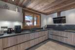 This stunning kitchen boasts a rustic charm with its wooden ceiling and cabinetry, creating a warm and inviting atmosphere.