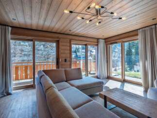Experience luxury living in this stunning property, featuring a spacious living area with floor-to-ceiling windows that offer breathtaking views.