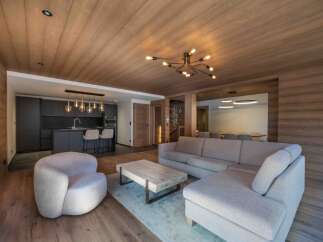 This stunning living space showcases a modern design with a touch of rustic charm.