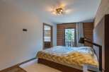 Experience the epitome of comfort in this stunning bedroom, featuring a cozy bed and a stylish lamp.